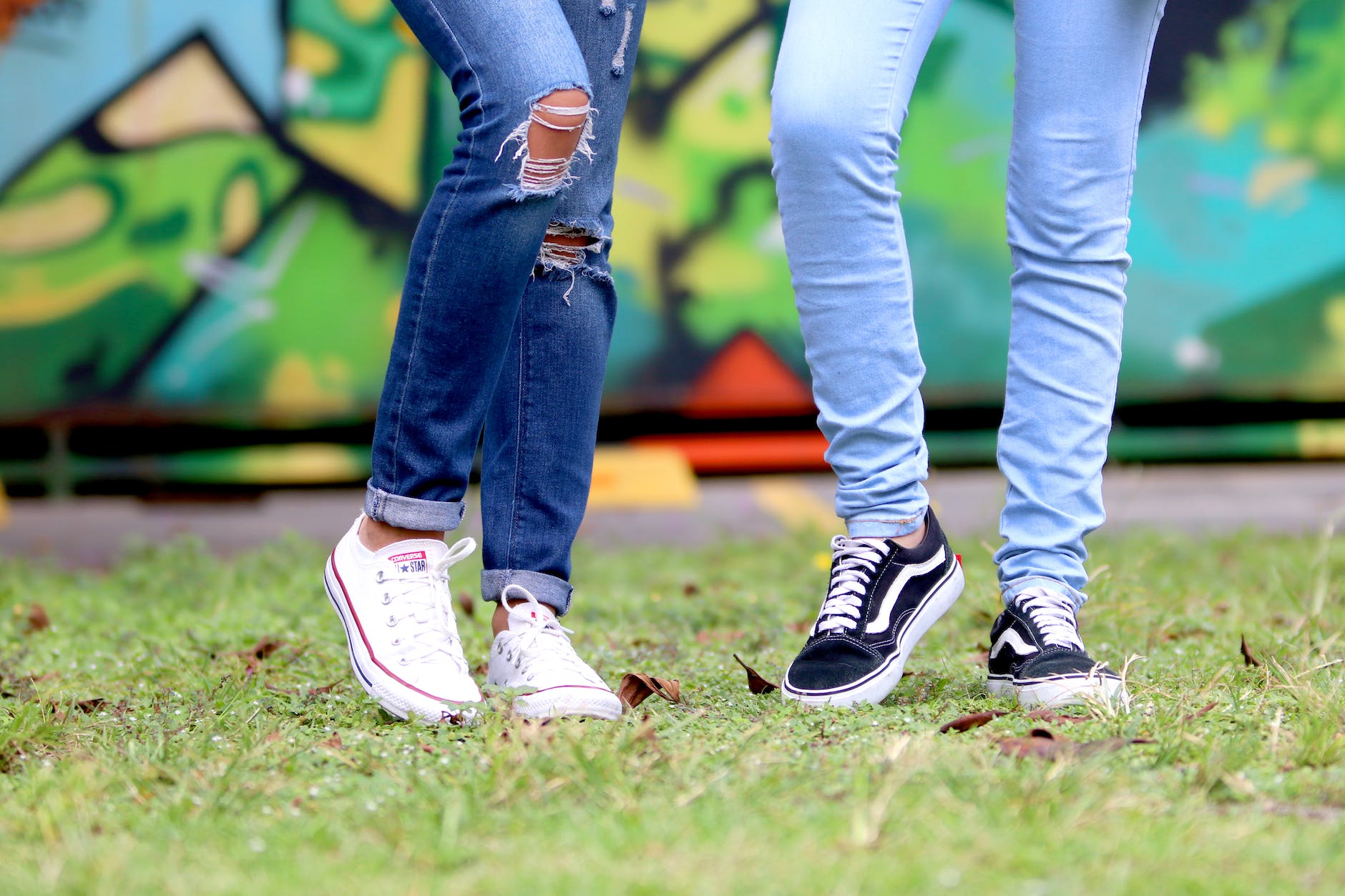 person s wearing white and black low top sneakers